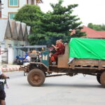 Monks on a tractor